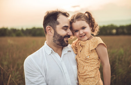 Happy family father with children daughter on nature sunsetの写真素材