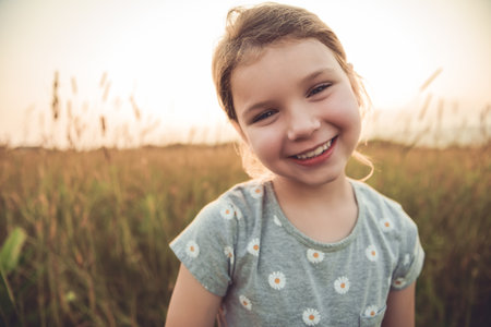 Girl in the sunlight in the fieldの写真素材