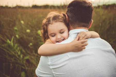 Happy family father with children daughter on nature sunsetの写真素材