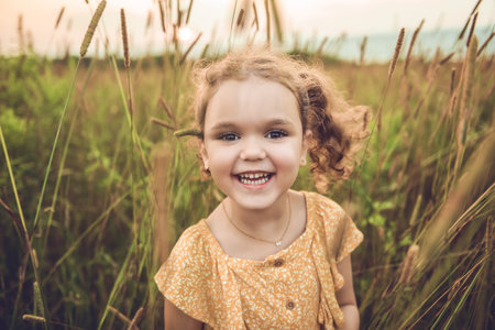 Girl in the sunlight in the fieldの写真素材