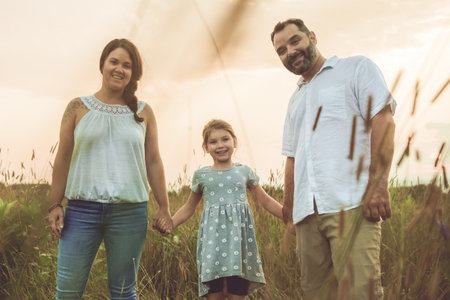 Happy family and her children daughter on nature sunset