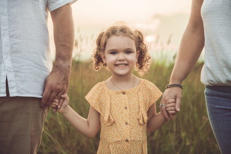 Happy family and her children daughter on nature sunsetの写真素材