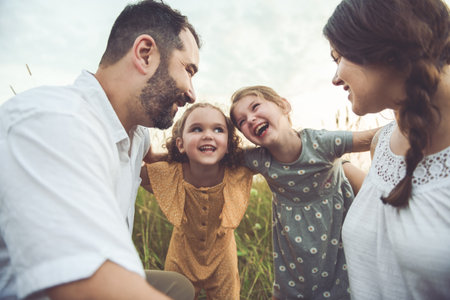 Happy family mother father and children daughter on nature sunsetの写真素材