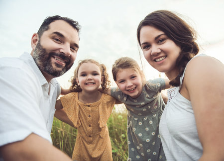 Happy family mother father and children daughter on nature sunsetの写真素材