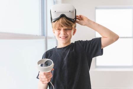 Little boy with VR glasses on living roomの写真素材