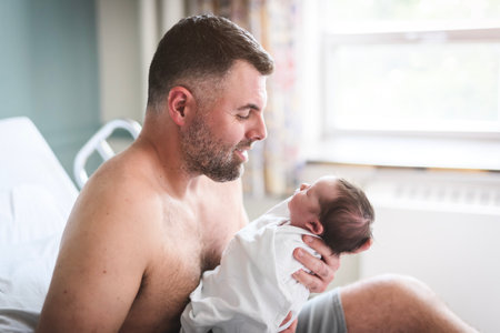 New born baby boy resting in father armsの写真素材