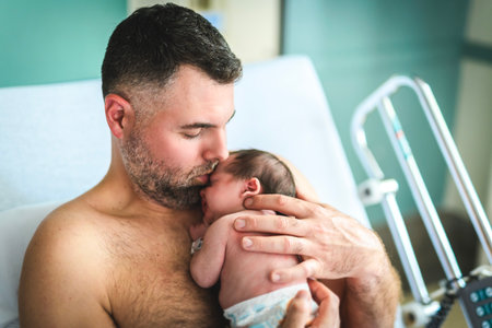 New born baby boy resting in father armsの写真素材