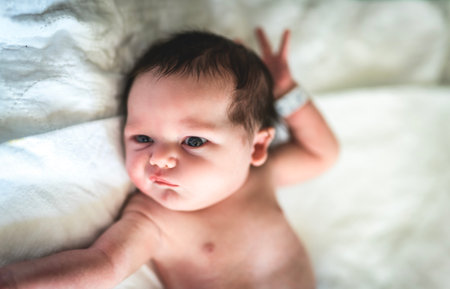 Adorable Caucasian Newborn Child Lying in Hospital Bedの写真素材
