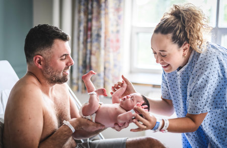 New born baby boy with the family in the hospital roomの写真素材
