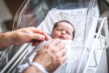 Adorable Caucasian Newborn Child Lying in Hospital Bedの写真素材