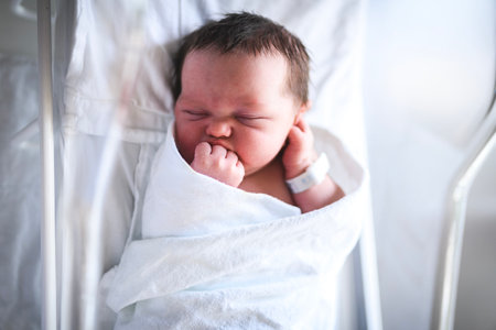 Adorable Caucasian Newborn Child Lying in Hospital Bed