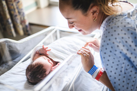 New born baby boy resting in little bed in hospitalの写真素材