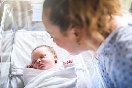 New born baby boy resting in little bed in hospitalの写真素材