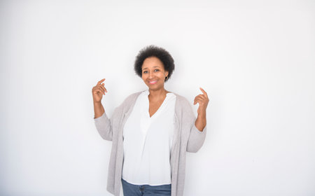 senior black American woman on white background pointing somethingの写真素材