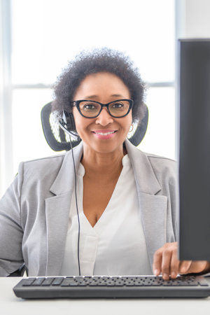nice Portrait of an black business woman sit at the office with microphone talk to clientの写真素材