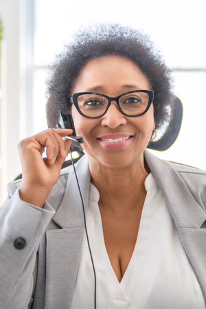 nice Portrait of an black business woman sit at the office with microphone talk to client