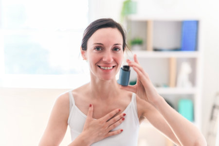 Female doctor with inhaler having asthma attack in clinicの写真素材
