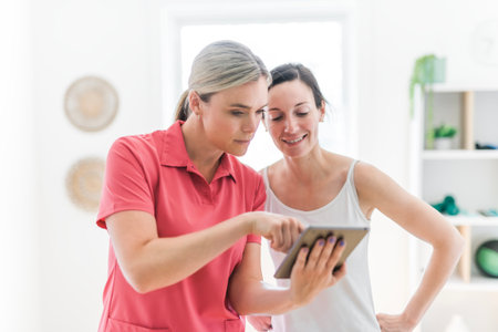 Modern rehabilitation physiotherapy clinic with professional and clientの写真素材