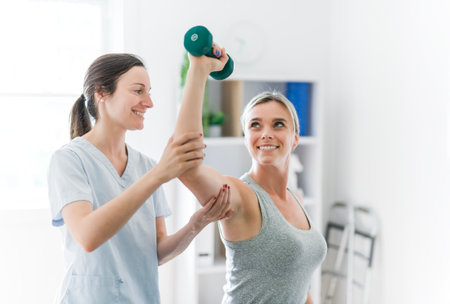 Modern rehabilitation physiotherapy clinic with professional and clientの写真素材