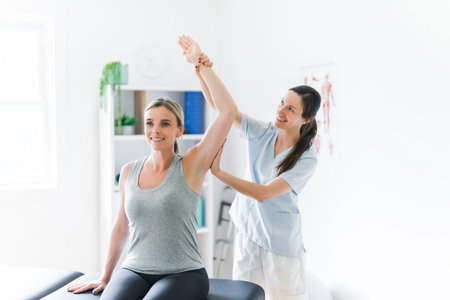 Modern rehabilitation physiotherapy clinic with professional and clientの写真素材