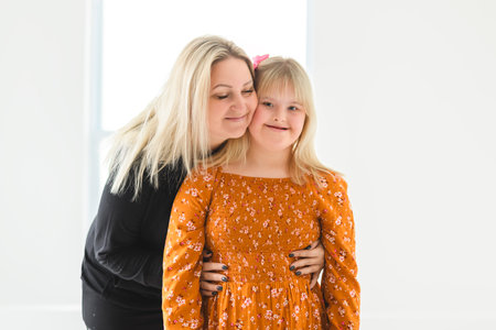 Mother and sweet down syndrome daughter girl at homeの写真素材