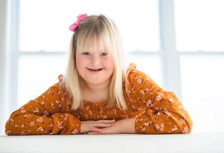 Portrait of beautiful little girl having down syndromeの写真素材