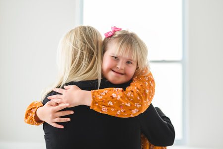 Mother and sweet down syndrome daughter girl at homeの写真素材