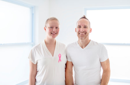 woman with Breast cancer in a bright room with her boyfriendの写真素材