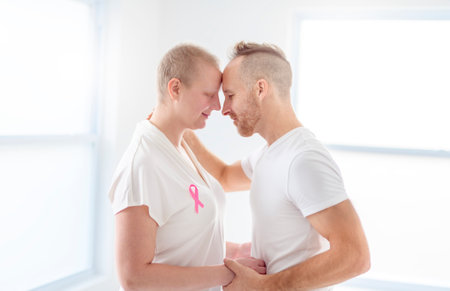 woman with Breast cancer in a bright room with her boyfriendの写真素材