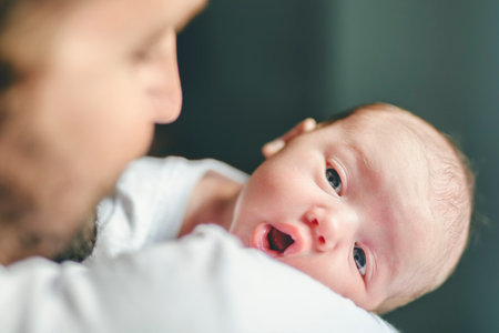 father on bedroom with his newborn baby sonの写真素材