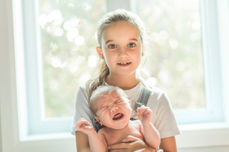 sister on bedroom with newborn son at home