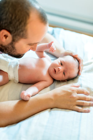 father on bedroom with his newborn baby sonの写真素材