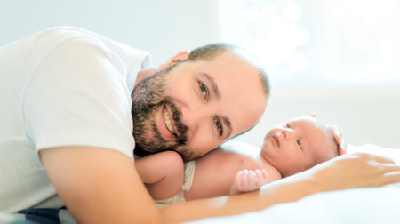 father on bedroom with his newborn baby sonの写真素材