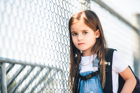 student girl wearing school backpack outside of the schoolの写真素材