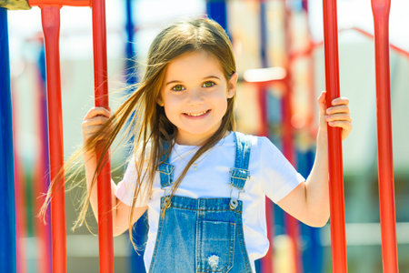 beautiful smiling cute girl on a playgroundの写真素材