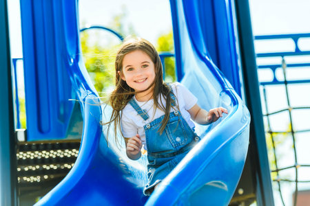 beautiful smiling cute girl on a playgroundの写真素材