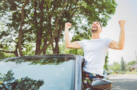 Mid adult man feeling comfortable with his new car.