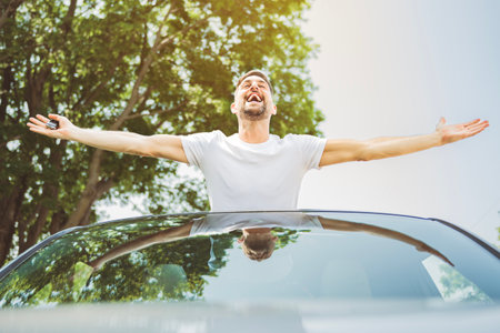 Mid adult man feeling comfortable with his new car.の写真素材
