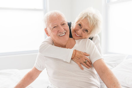 Senior 80 years old Couple Relaxing In Bed togetherの写真素材