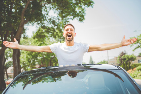 Mid adult man feeling comfortable with his new car.の写真素材
