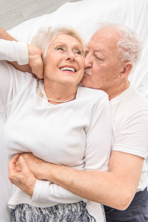 Senior 80 years old Couple Relaxing In Bed together