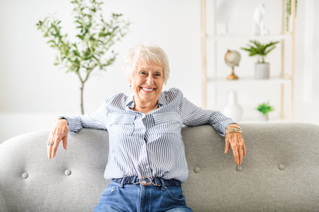 Smiling mature grey senior woman looking at cameraの写真素材