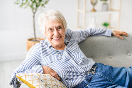 Smiling mature grey senior woman looking at cameraの写真素材
