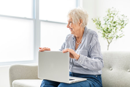 senior women using a laptop while sitting at the office