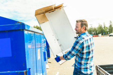 worker who recycling cardboard on recycle centerの写真素材