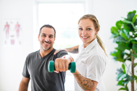 Modern rehabilitation physiotherapy woman with man clientの写真素材
