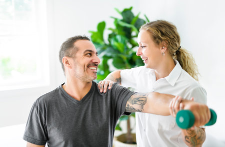 Modern rehabilitation physiotherapy woman with man clientの写真素材