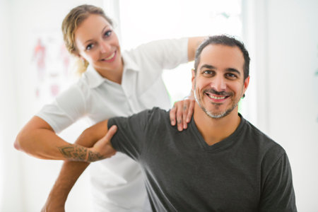 Modern rehabilitation physiotherapy woman with man clientの写真素材