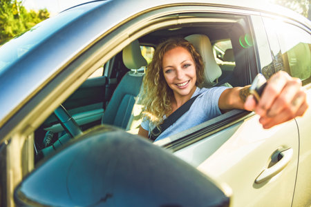 Portrait of joyful woman driving a car and having fun