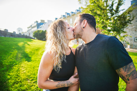 Beautiful couple having kiss outdoors on urban background